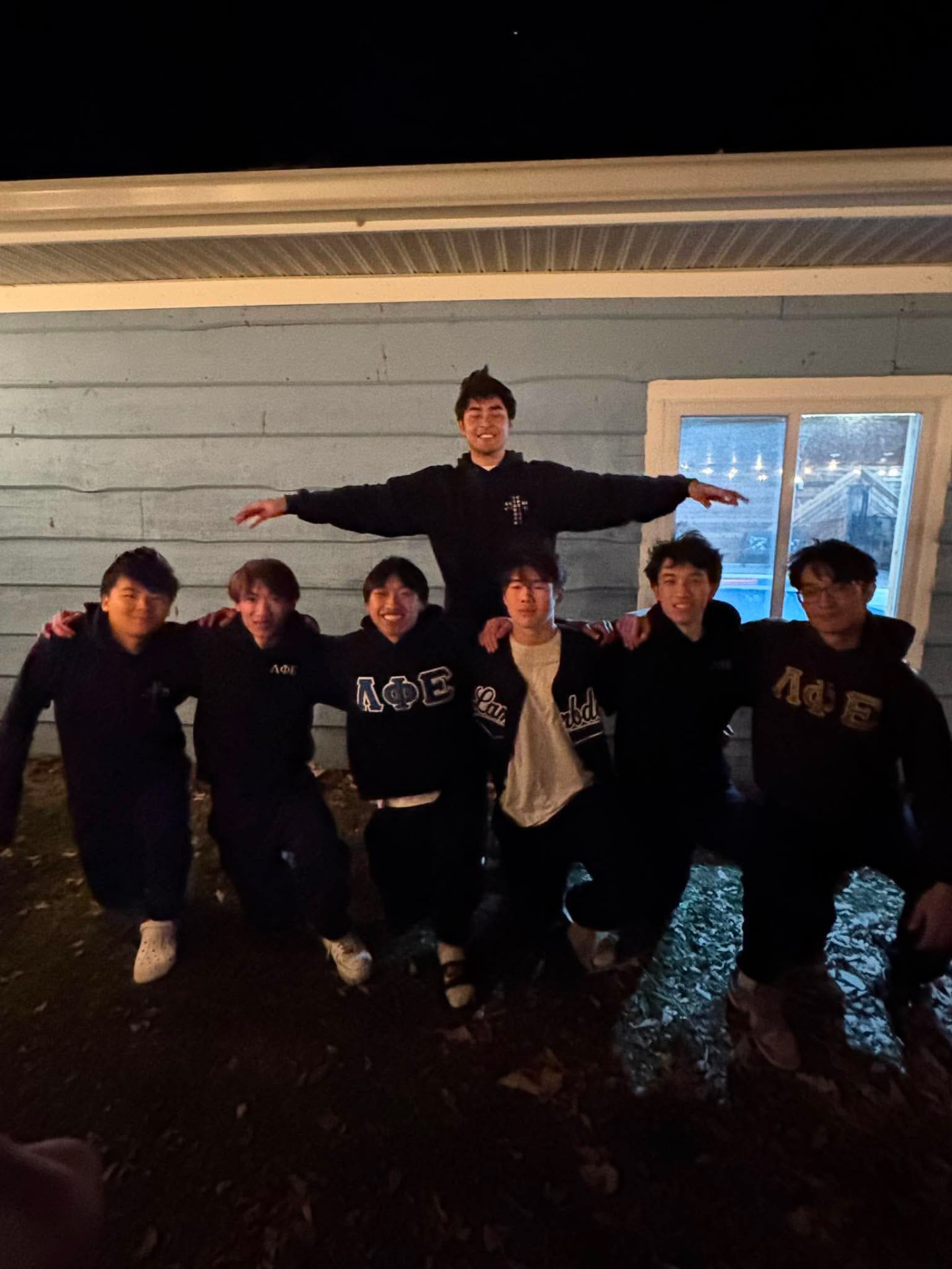 A group of Xi Chapter brothers gathering outdoors.